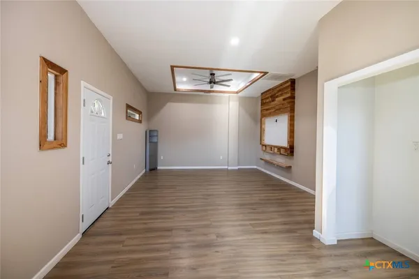 a view of a hallway with wooden floor