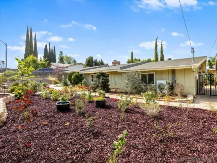 a view of a house with backyard sitting area and swimming pool