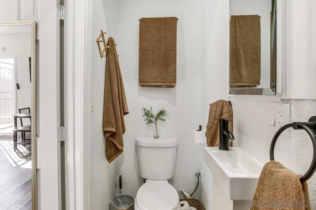 5595 Sweetwater Road Bonita, CA 91902 - Photo 12 of 15 a bathroom with a toilet a sink and mirror