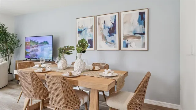 a dining room with furniture and wooden floor