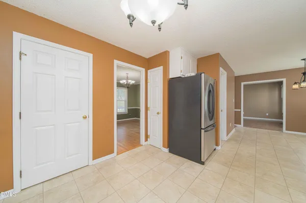 a view of a hallway with closet and a bathroom