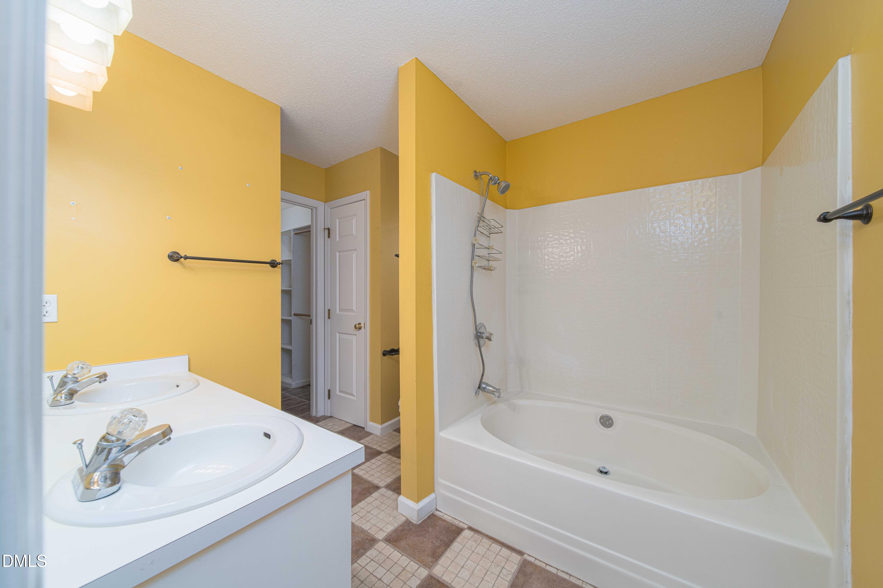 3002 Red Circle Willow Spring, NC 27592 - Photo 17 of 27 a bathroom with a tub sink and a mirror