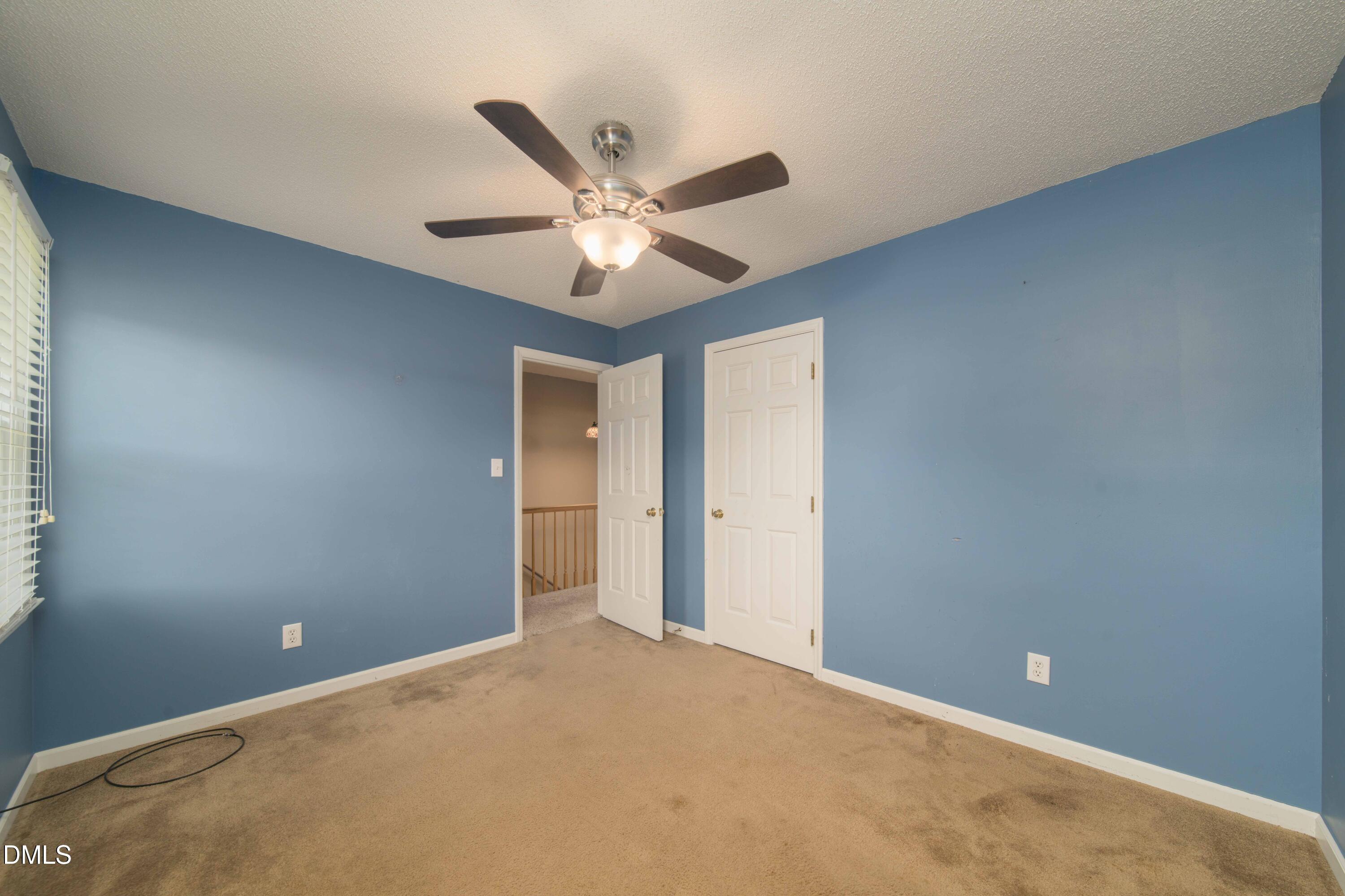 3002 Red Circle Willow Spring, NC 27592 - Photo 20 of 27 an empty room with a ceiling fan and a window