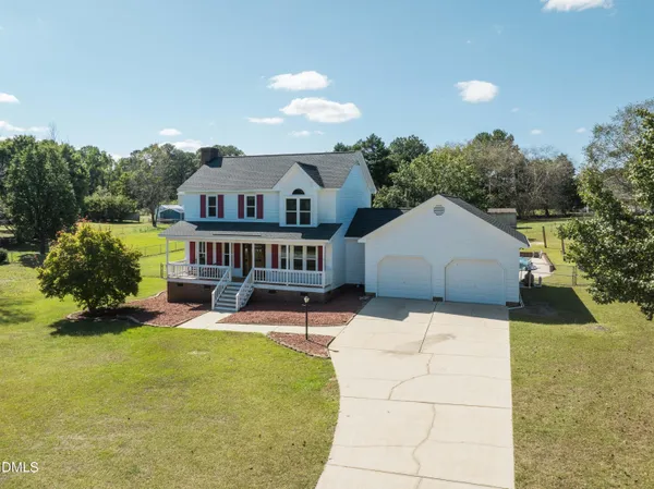 a house view with a seating space and garden