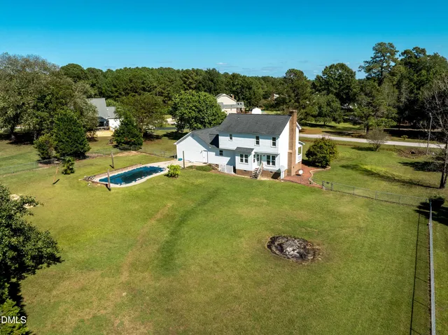 a view of a swimming pool with a yard