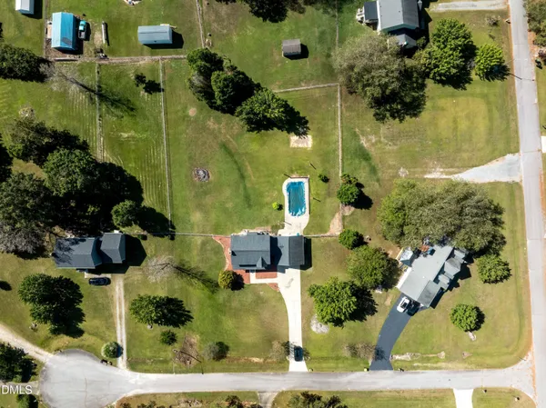 an aerial view of a house with a yard