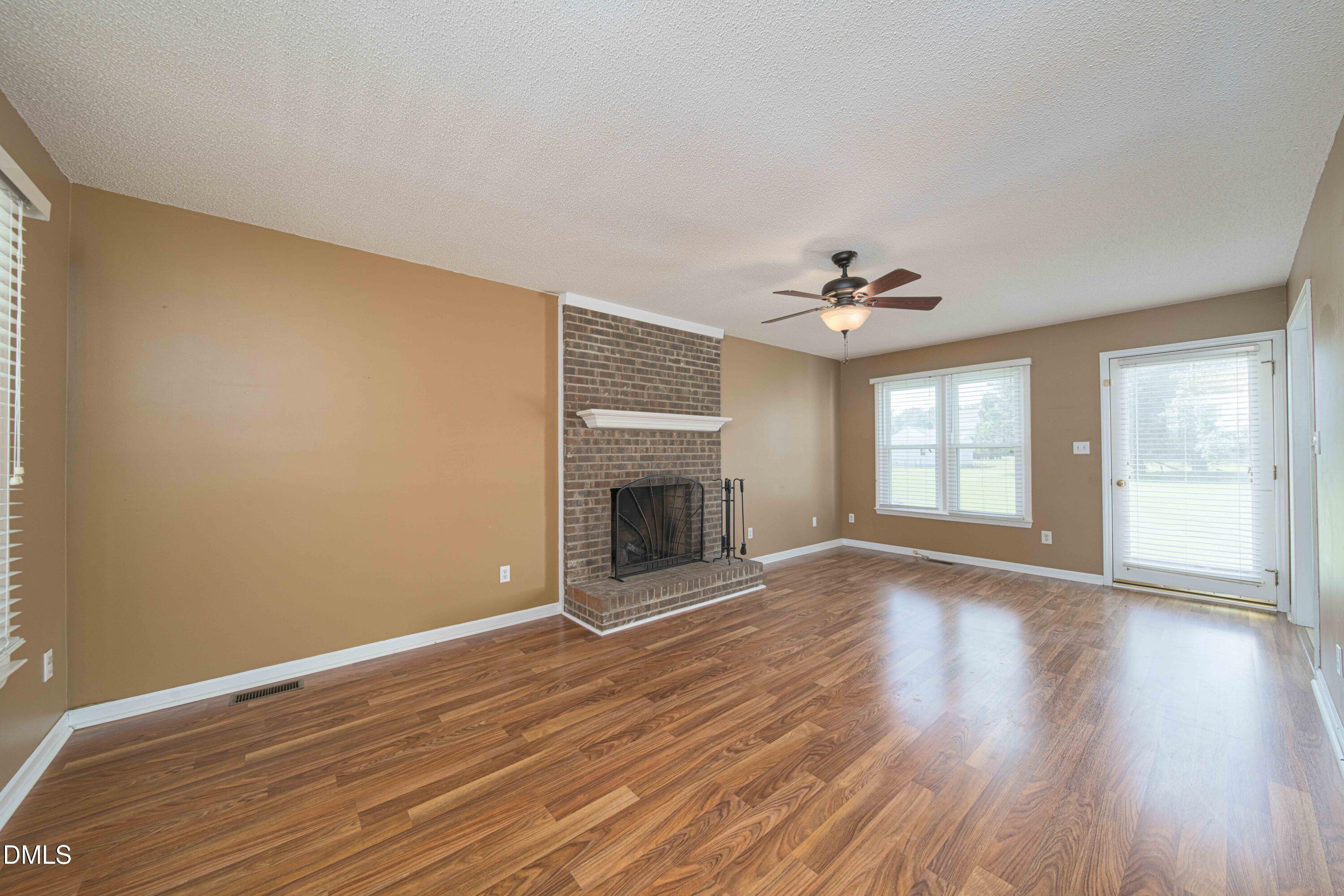 3002 Red Circle Willow Spring, NC 27592 - Photo 6 of 27 a view of an empty room with a window and wooden floor