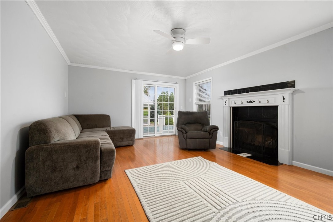 1322 Sawmill Road Sangerfield, NY 13480 - Photo 14 of 50 Polished hardwood floors and a classic fireplace anchor this comfortable living space.