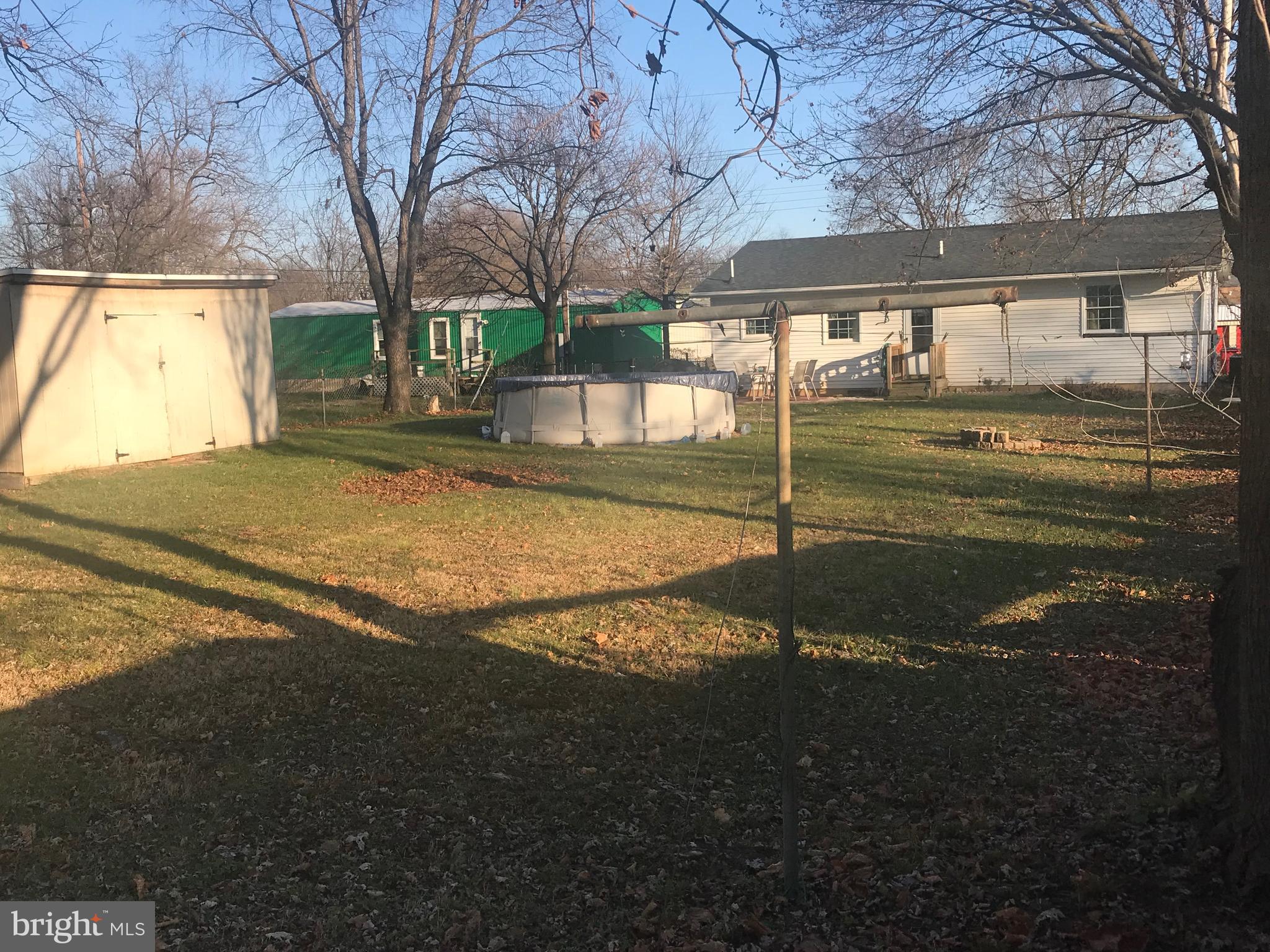 Enjoy a large fenced  yard with pool and swing set