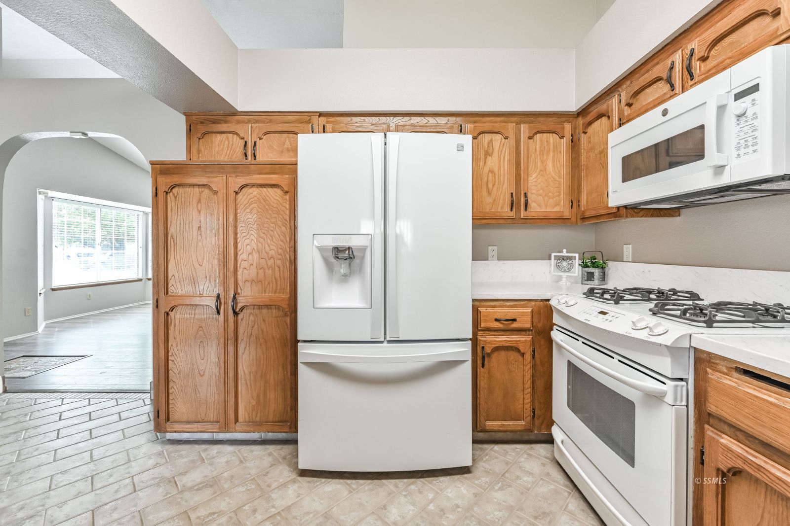131 Chambers Street Ridgecrest, CA 93555 - Photo 5 of 28 a kitchen with stainless steel appliances granite countertop a refrigerator a stove and a sink with dishwasher