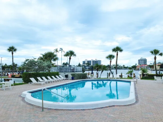 a view of a swimming pool with outdoor seating