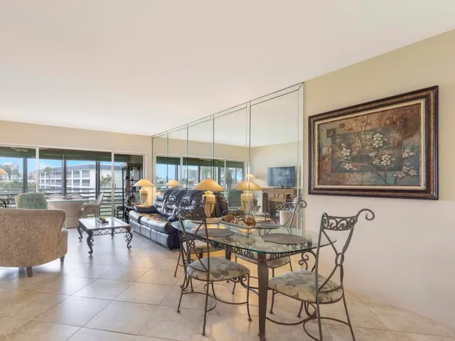 a living room with fireplace furniture and a floor to ceiling window