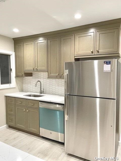 a kitchen with stainless steel appliances granite countertop a refrigerator a sink and a refrigerator