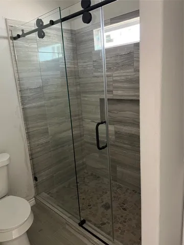 a bathroom with a shower and toilet