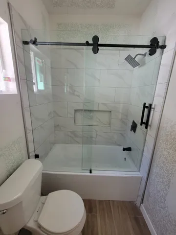 a bathroom with a toilet and a bath tub