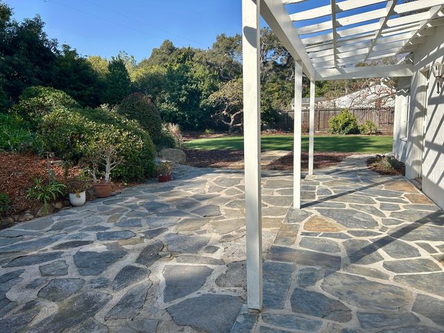 a view of a porch with a floor to ceiling window and tree