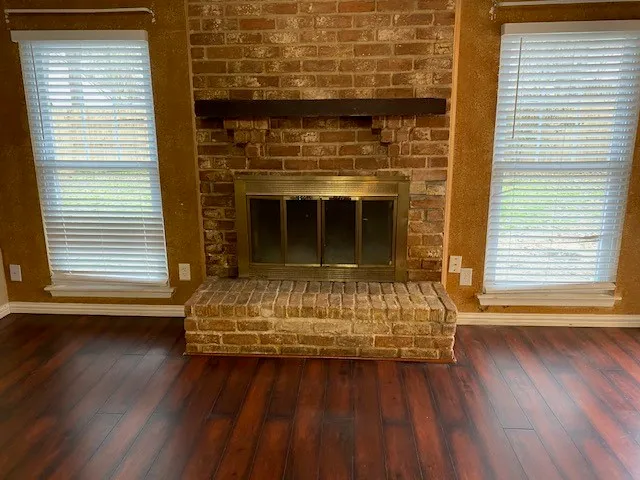 a view of fireplace with wooden floor