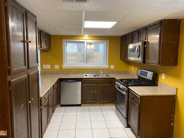a kitchen with stainless steel appliances granite countertop a stove and a refrigerator
