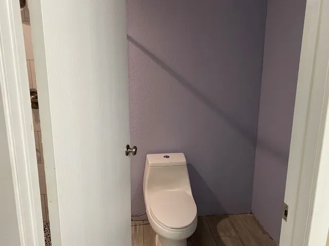 a white toilet sitting in a bathroom