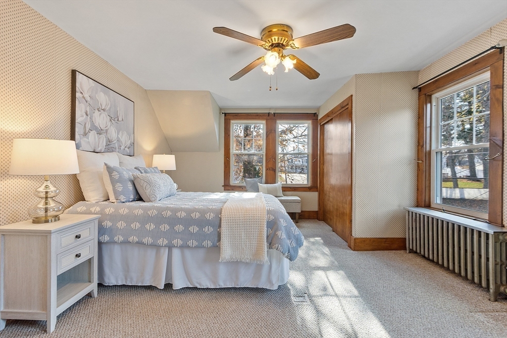 7 Groton-Harvard Road Ayer, MA 01432 - Photo 17 of 35 a spacious bedroom with a large bed and a chandelier fan