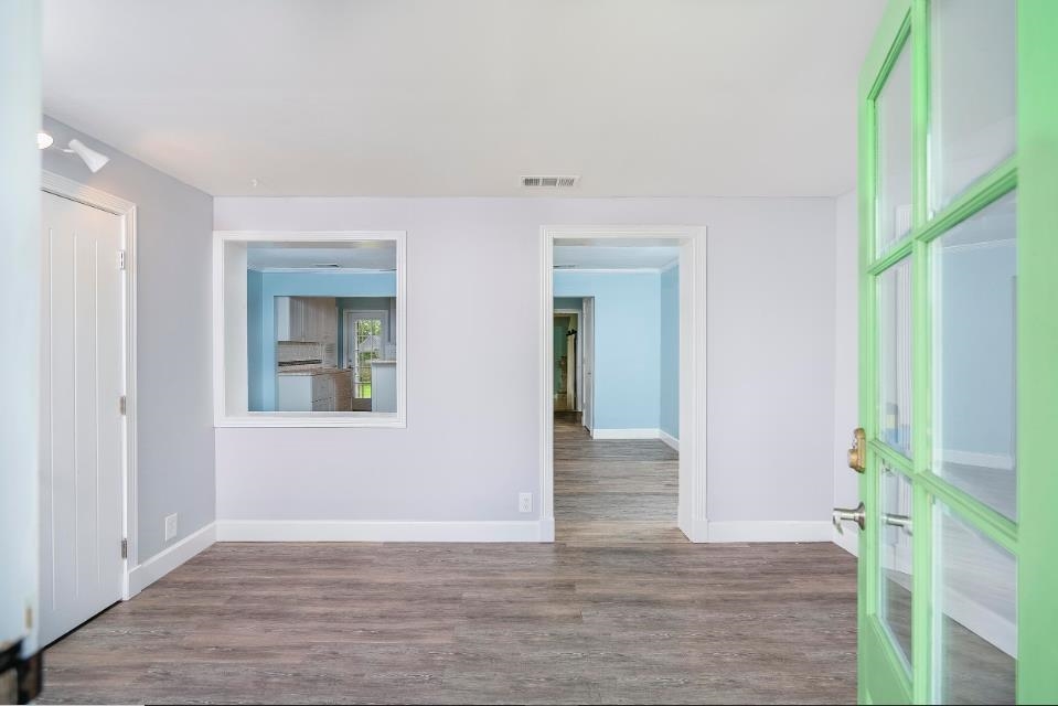 144 Menendez Road St. Augustine, FL 32080 - Photo 5 of 16 Spare room featuring dark wood-type flooring and baseboards
