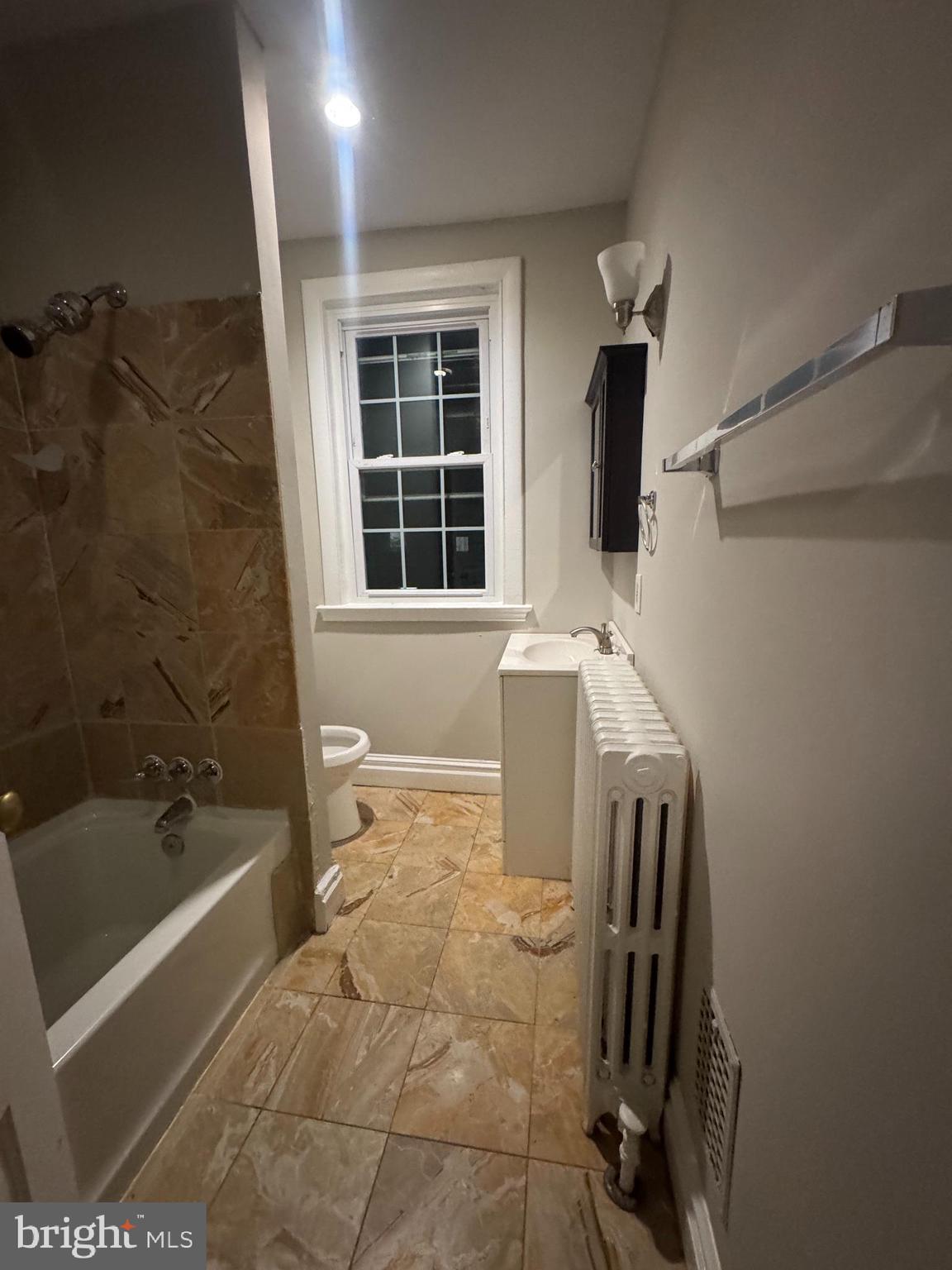 228 Ascot Place Northeast Washington, DC 20002 - Photo 11 of 14 a bathroom with a sink a bathtub and next to a window