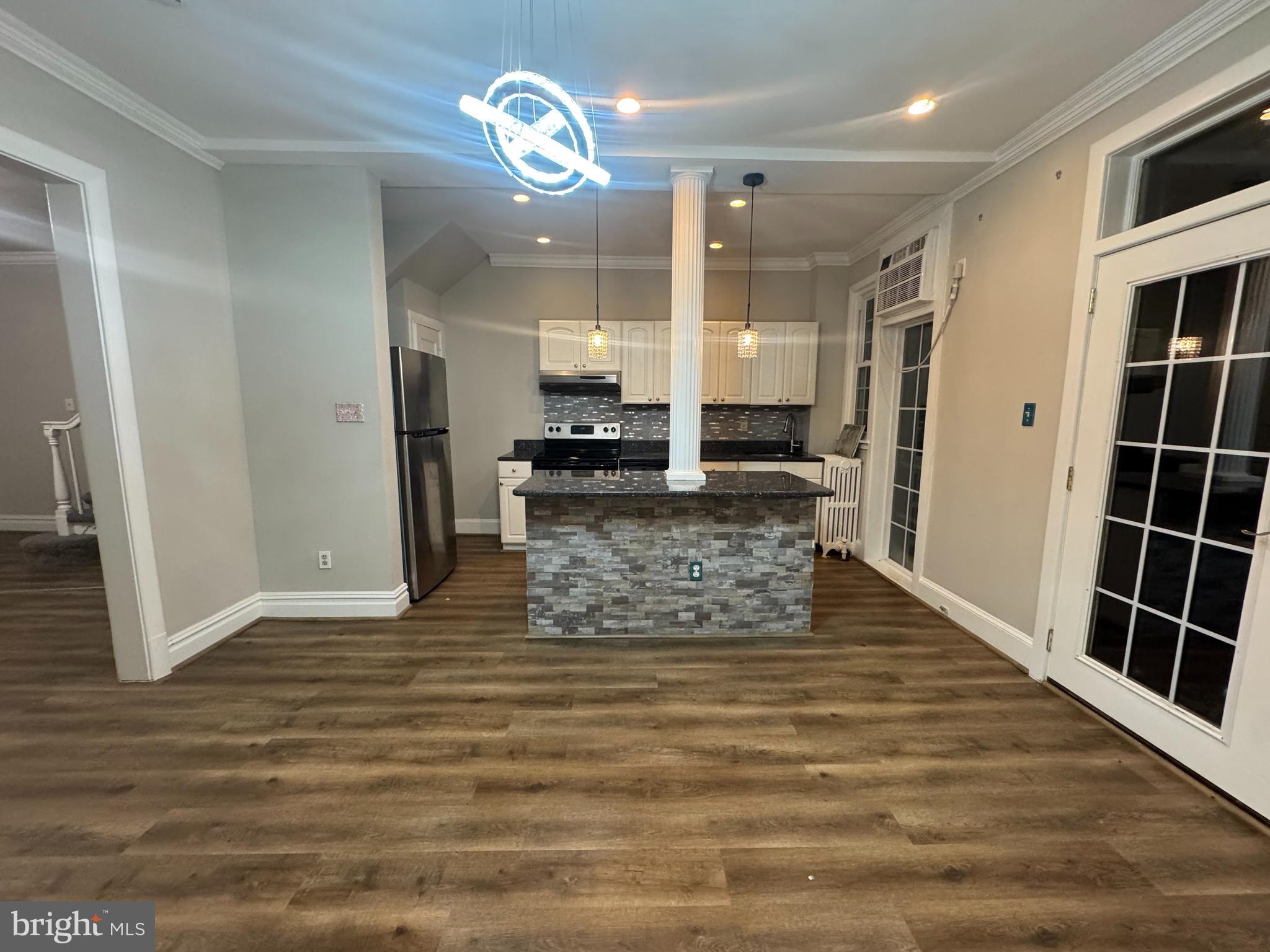 228 Ascot Place Northeast Washington, DC 20002 - Photo 6 of 14 a view of a hallway with wooden floor and chandelier