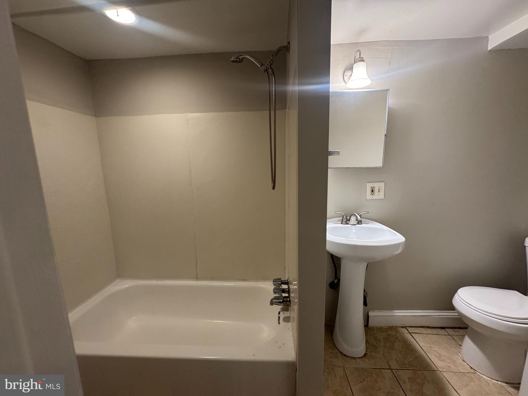 228 Ascot Place Northeast Washington, DC 20002 - Photo 8 of 14 a bathroom with a sink toilet and shower