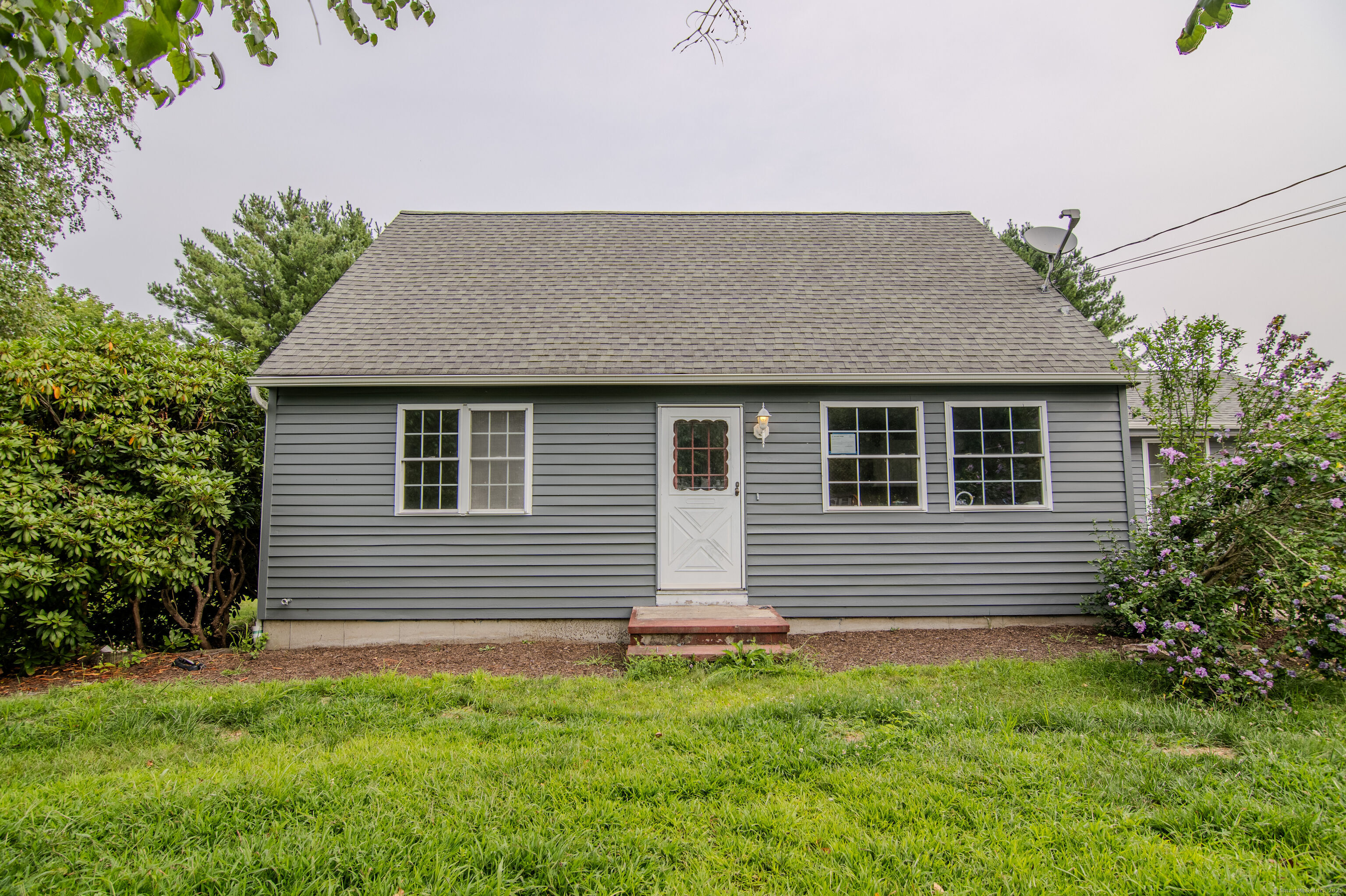 a front view of a house with a garden