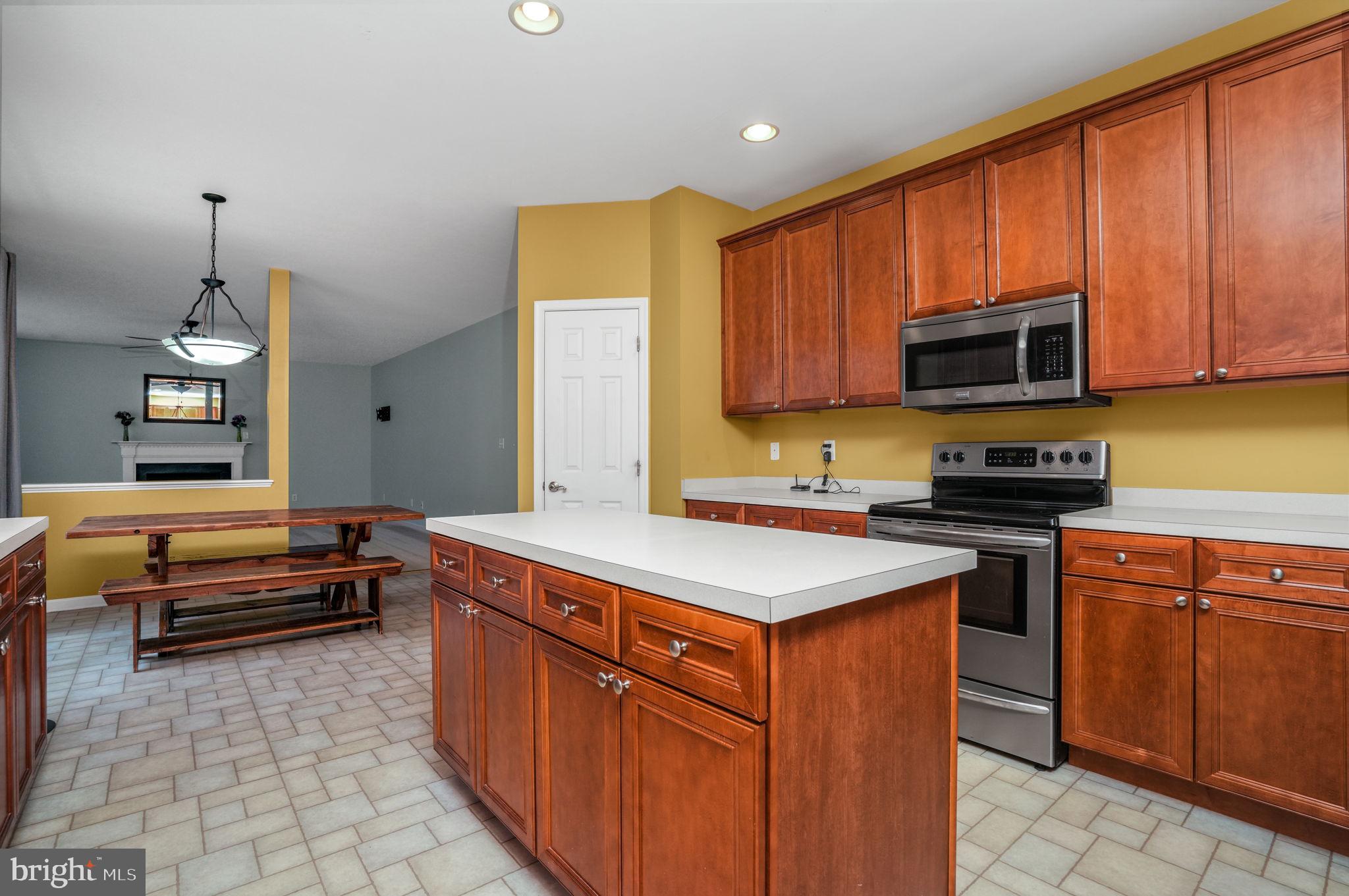 2745 Stockton Road Pocomoke City, MD 21851 - Photo 20 of 57 a kitchen with stainless steel appliances granite countertop a stove a sink and a microwave