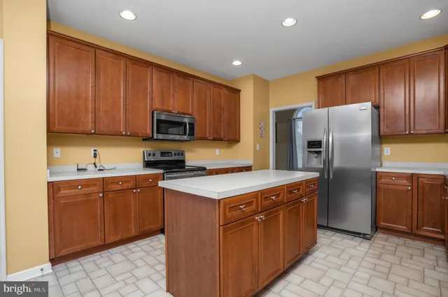 a outdoor kitchen with a table and chairs
