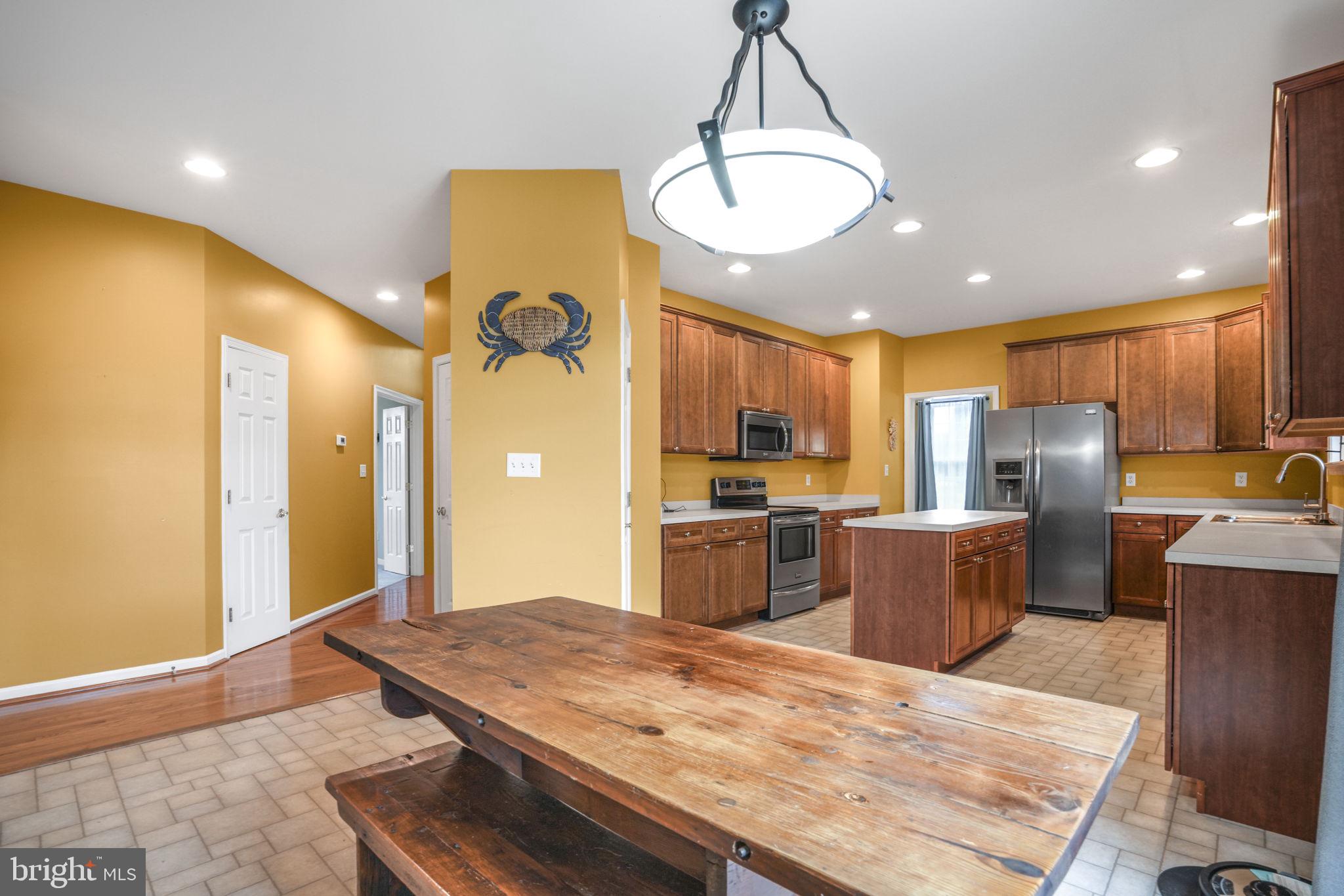 2745 Stockton Road Pocomoke City, MD 21851 - Photo 24 of 57 a kitchen with stainless steel appliances kitchen island granite countertop a sink refrigerator and cabinets