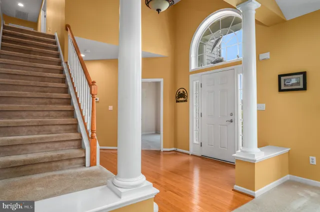 a view of a livingroom with wooden floor and stairs