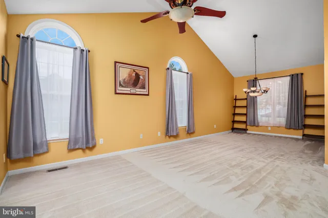 a view of an entryway with wooden floor windows and a livingroom