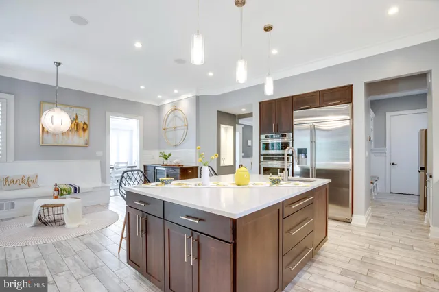 a bedroom with a large bed and a large window with couch