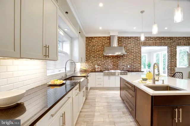 a spacious bedroom with a large bed and a chandelier