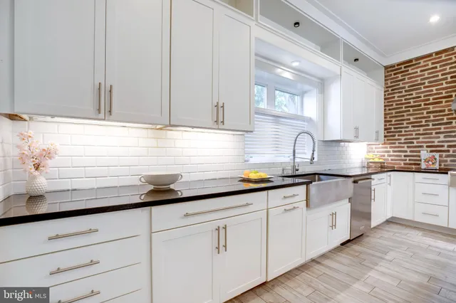 a spacious bathroom with a granite countertop sink and a mirror