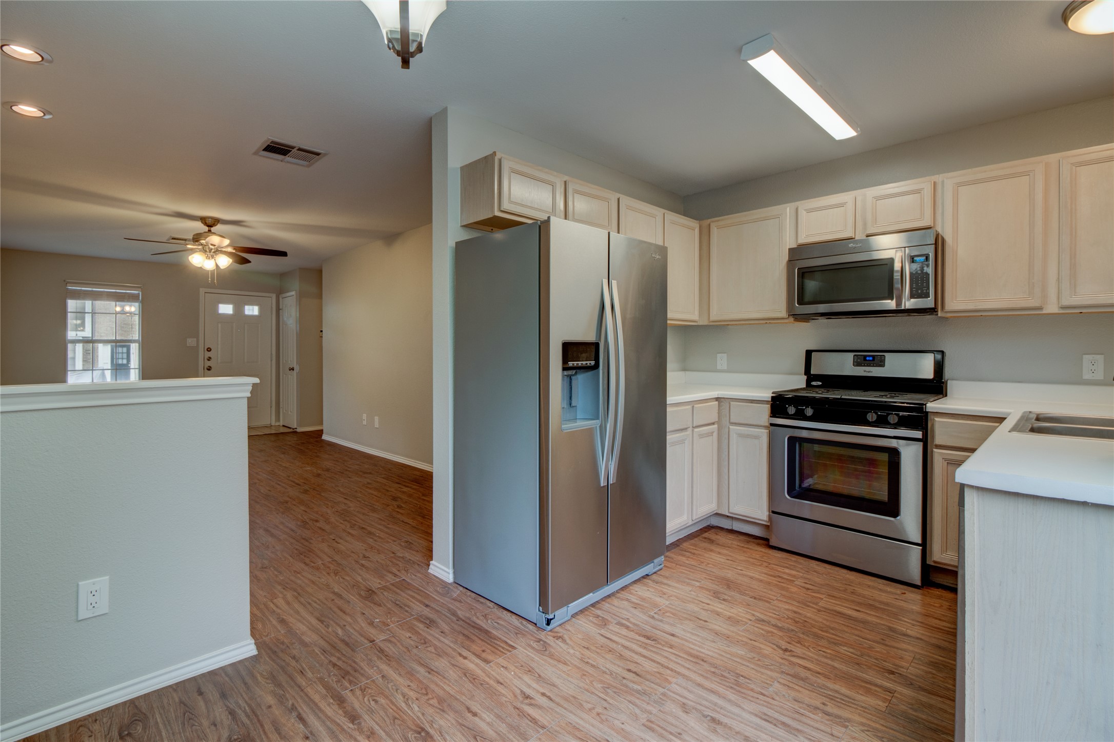202 South College Street, Unit 2 Georgetown, TX 78626 - Photo 19 of 31 A well-equipped kitchen offers stainless steel appliances and abundant cabinetry, flowing into a bright entryway.