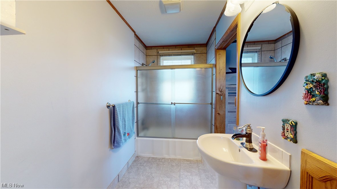 6755 State Rte 5 Ravenna, OH 44266 - Photo 12 of 34 Bathroom with sink, tile floors, and shower / bath combination with glass door