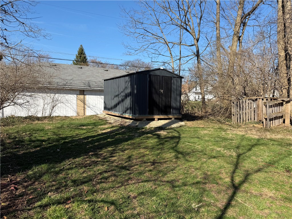 230 West Decatur Street Eaton, OH 45320 - Photo 21 of 22 This spacious backyard offers ample room for outdoor activities and features a functional storage shed.