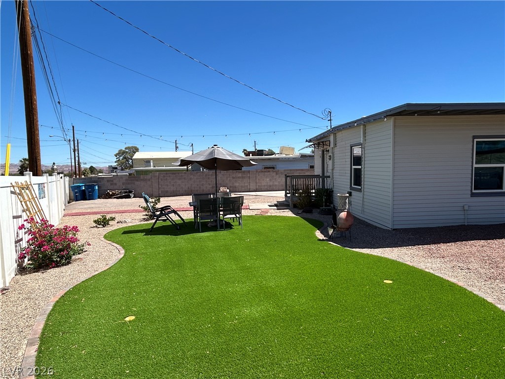 116 West Basic Road Henderson, NV 89015 - Photo 4 of 39 A private yard with maintenance-free turf and gravel borders provides a serene outdoor escape.