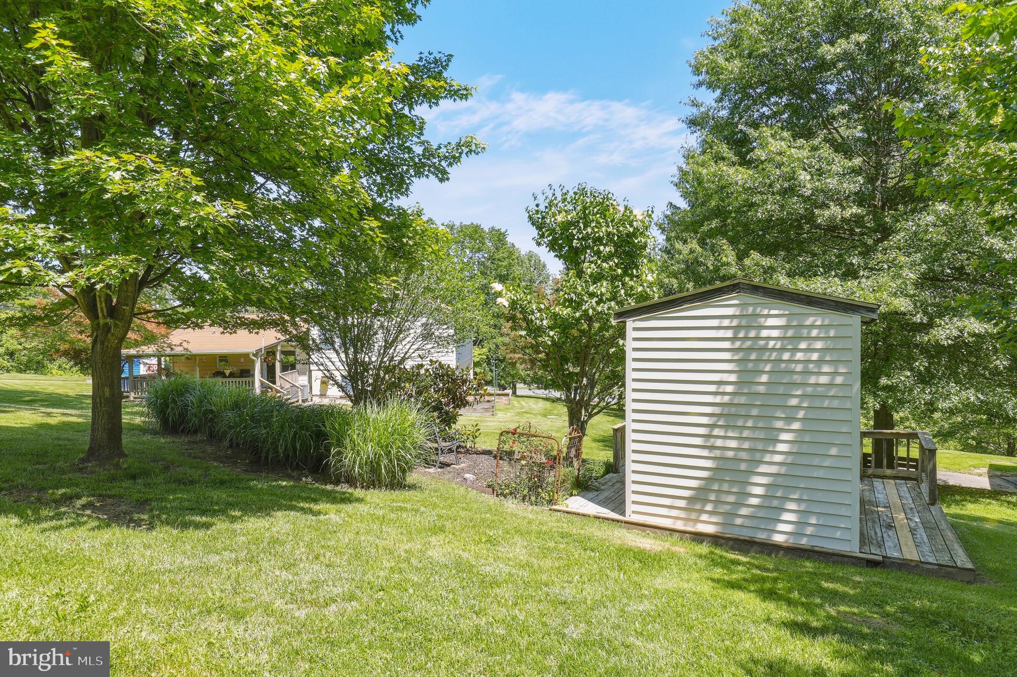 6336 Boyers Mill Road New Market, MD 21774 - Photo 48 of 49 a view of a backyard with plants and large trees