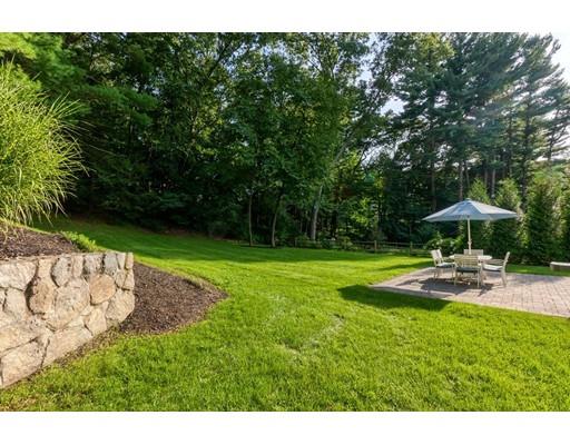 130 Ridge Road Concord, MA 01742 - Photo 24 of 26 a view of a backyard with a garden and trees