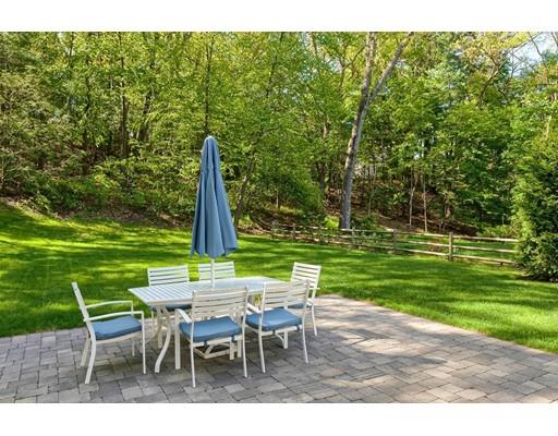 130 Ridge Road Concord, MA 01742 - Photo 4 of 26 a view of a wooden dinning table and chairs in the garden