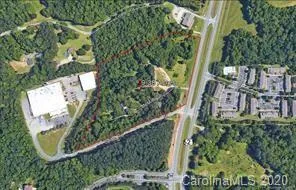an aerial view of a residential houses with yard
