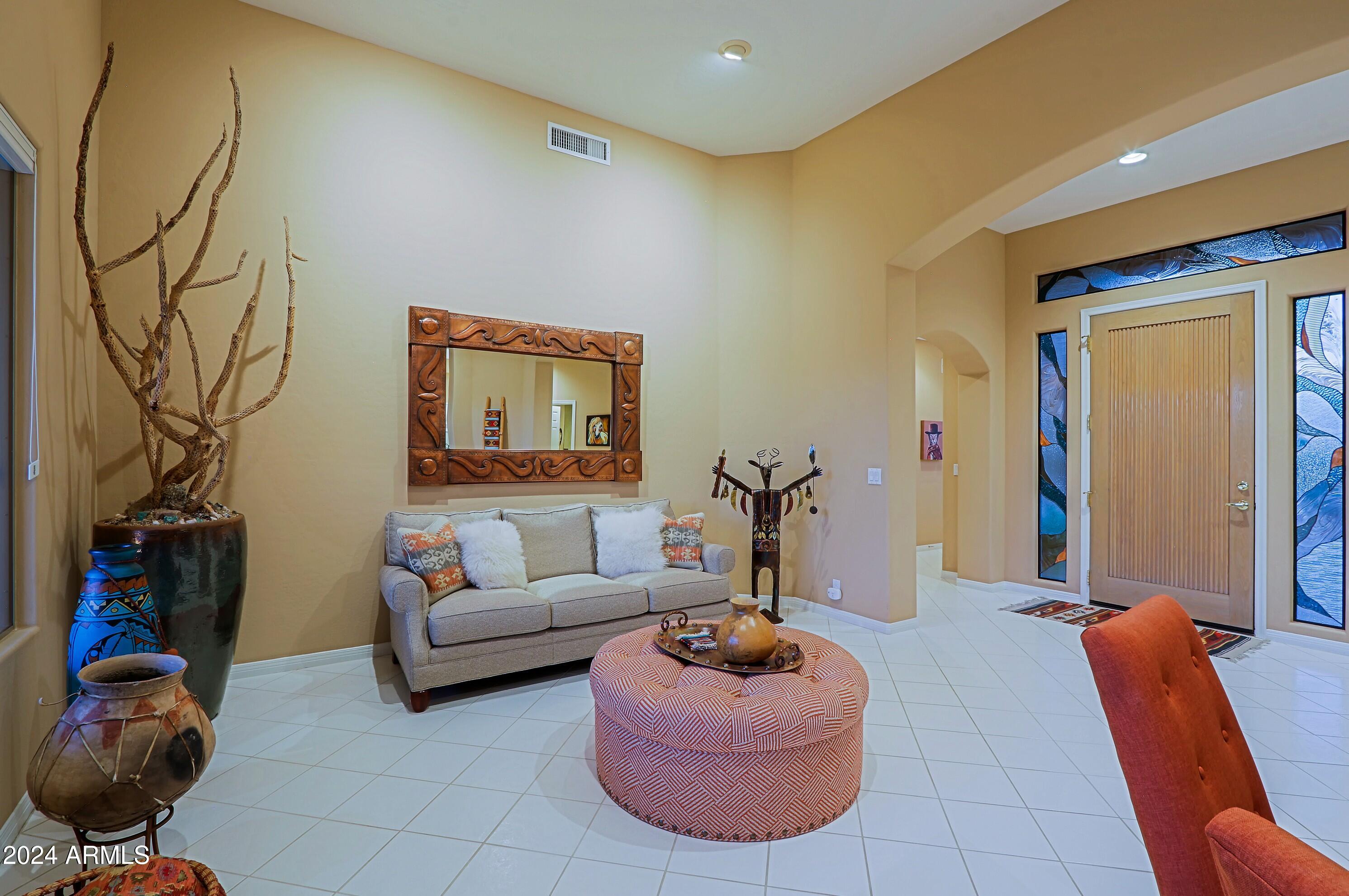 6135 East Evening Glow Drive Scottsdale, AZ 85266 - Photo 10 of 118 a living room with furniture a couch and a closet