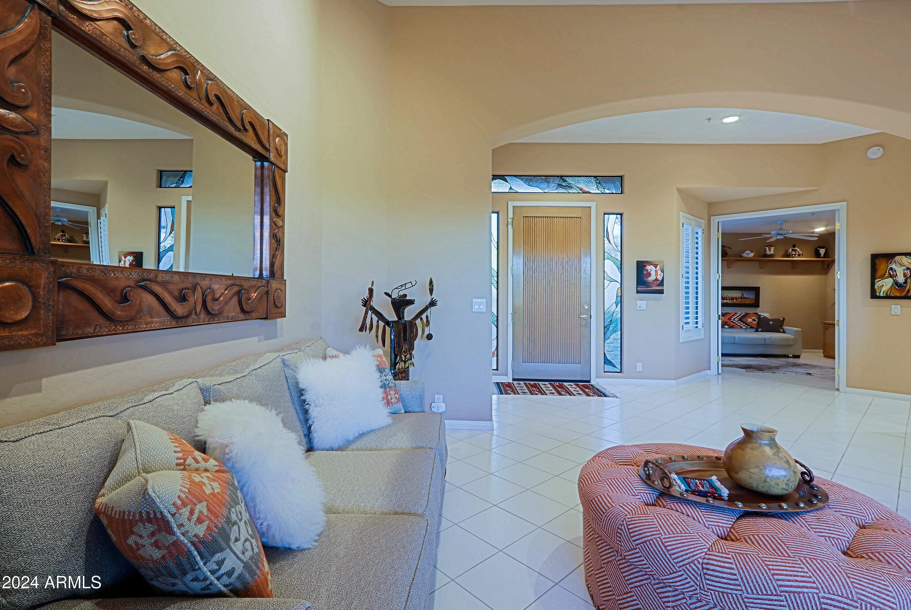 6135 East Evening Glow Drive Scottsdale, AZ 85266 - Photo 16 of 118 a living room with furniture and a mirror