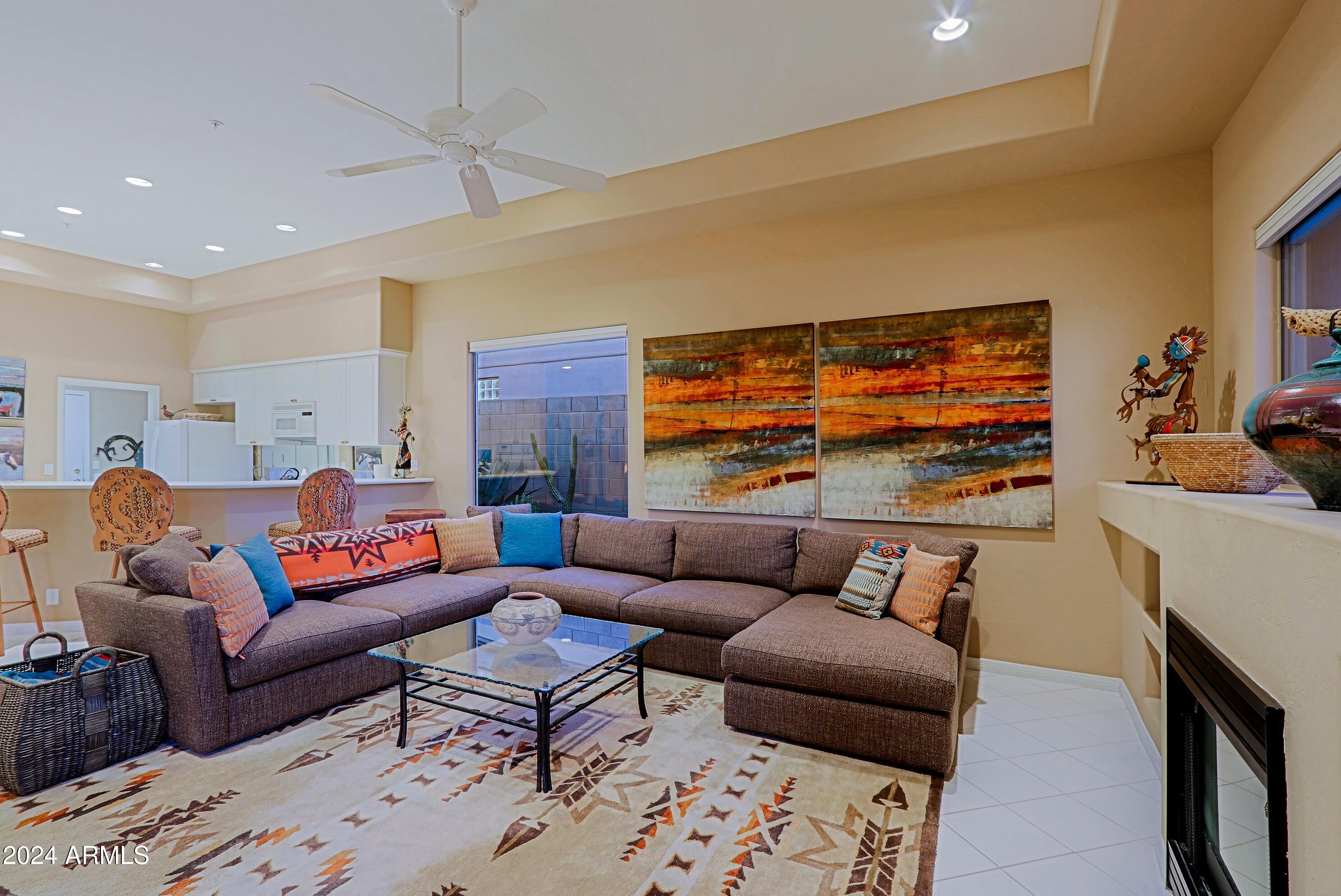 6135 East Evening Glow Drive Scottsdale, AZ 85266 - Photo 17 of 118 a living room with furniture a rug and a flat screen tv