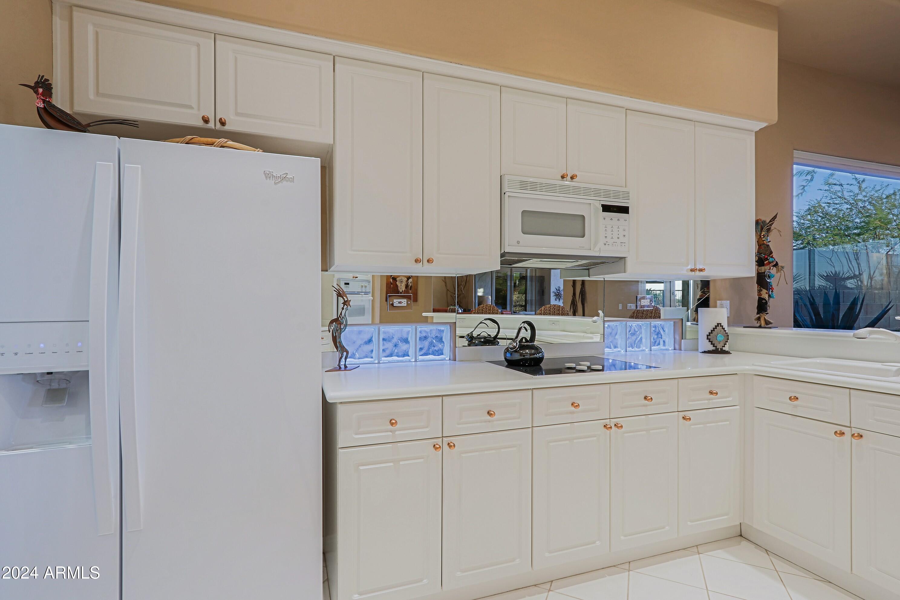 6135 East Evening Glow Drive Scottsdale, AZ 85266 - Photo 26 of 118 a kitchen with white cabinets and white appliances