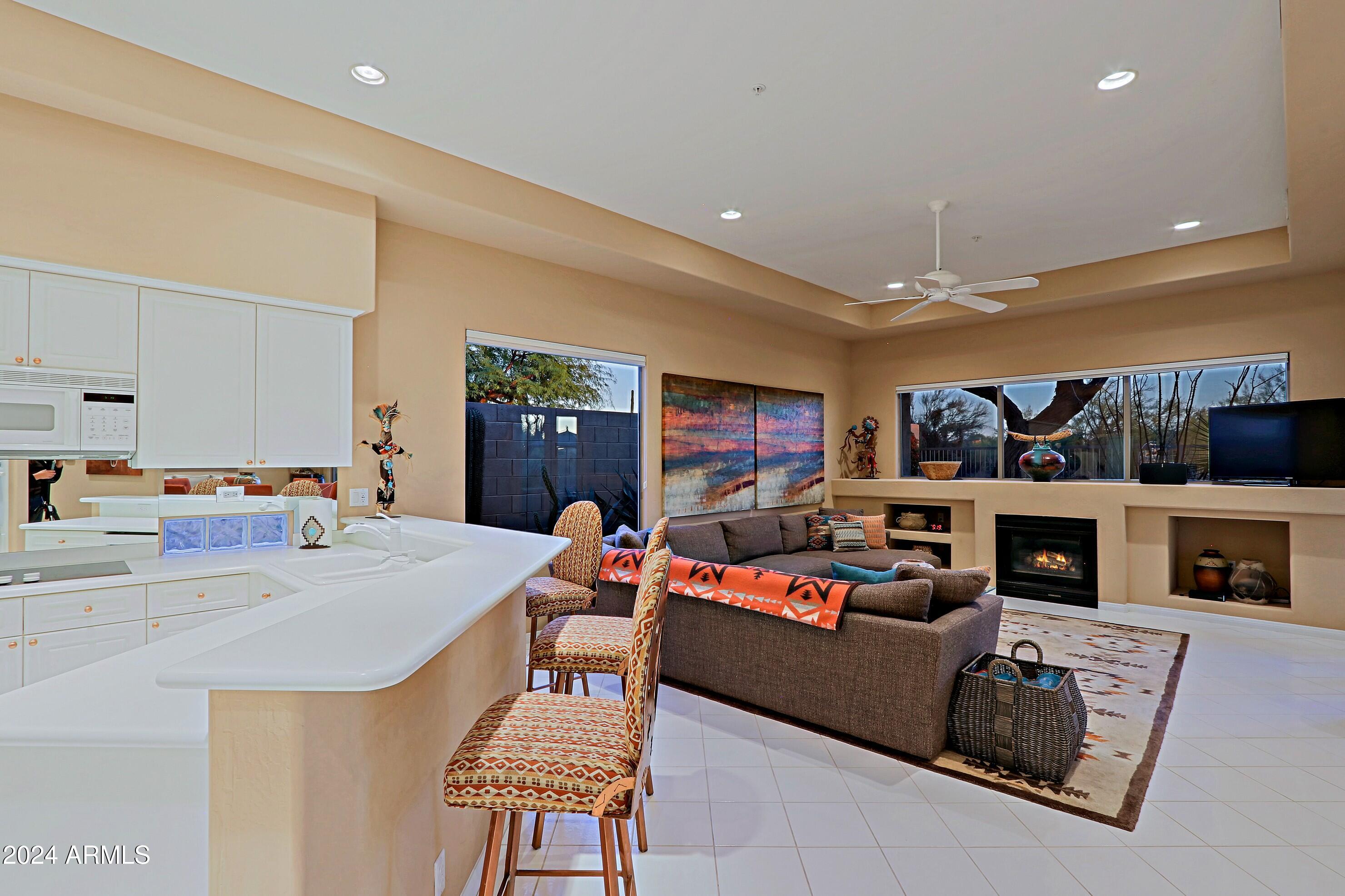 6135 East Evening Glow Drive Scottsdale, AZ 85266 - Photo 28 of 118 a living room with fireplace furniture and a flat screen tv
